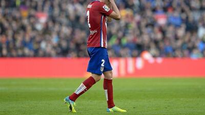 Atletico Madrid’s Diego Godin leaves the pitch after his second yellow to leave Atleti with nine men on Saturday against Barcelona. Josep Lago / AFP