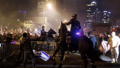 A mounted Israeli police officer clashes with demonstrators on the Ayalon motorway during the anti-government protests. Bloomberg
