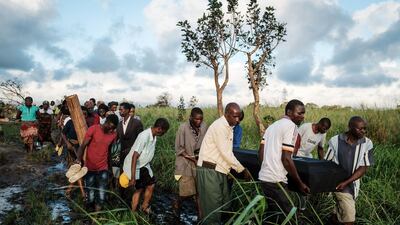 People carry the coffin of Tomas Joaquim Chimukme during his funeral, after his home collapsed following a strong cyclone that hit Beira, Mozambique. AFP