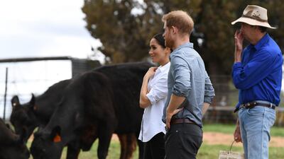 Britain's Prince Harry and his wife Meghan, Duchess of Sussex, chat with farmer Scott Woodley during a visit to his family's drought-affected farm called Mountain View near Dubbo on October 17, 2018. AFP