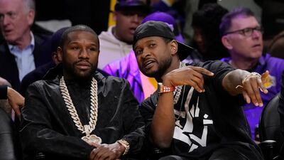Boxer Floyd Mayweather Jr, left, with singer Usher at the game between LA Lakers and and Oklahoma City Thunder in California. AP
