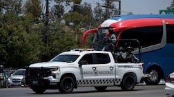 Members of Mexico's National Guard escort the bus transporting Iran's national football team after a training session in Tijuana, Mexico, on June 8, 2026, ahead of the FIFA 2026 World Cup football tournament. (Photo by Guillermo Arias / AFP)