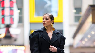 Olivia Culpo in a Jacquemus coat and Johanna Ortiz jumpsuit with Jimmy Choo shoes and a Dior handbag. Getty