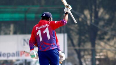 Nepal captain Gyanendra Malla celebrates his half-century against Oman on Sunday. Subas Humagain for The National