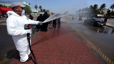 A member of a medical team sprays disinfectant as Iraqi Shiite pilgrims make their way to the tomb of Mousa al-Kadhim to mark his death anniversary in the Kadhimiyah district of Baghdad, Iraq. EPA