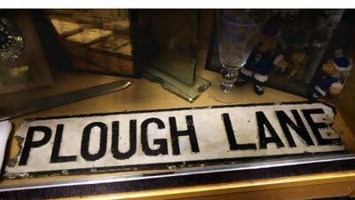 ENGLAND. 12th January 2011. The Plough Lane street sign, the name of AFC Wimbledon's former ground inside the trophy cabinet at their new stadium in Kingston upon Thames, England. FOR SPORT. words: Rob Shepherd. Stephen Lock for The National