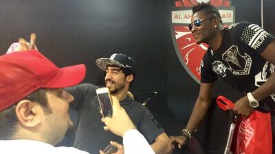 Ghanaian footballer Asamoah Gyan takes a selfie with a fan at his Al Ahli introduction press conference on Sunday. John McAuley / The National