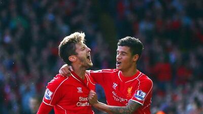 Adam Lallana is congratulated by teammate Philippe Coutinho after scoring in Liverpool's 2-1 win over West Bromwich Albion at Anfield on October 4, 2014. Clive Brunskill / Getty Images