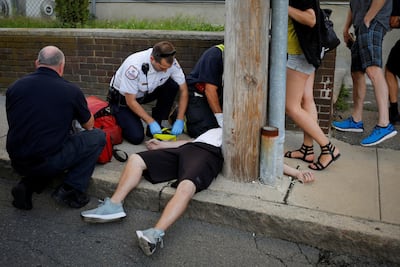 Medics and other first responders revive a 32-year-old unresponsive man found not breathing after an opioid overdose on a sidewalk in the Boston suburb of Everett, Massachusetts, US August 23, 2017. Reuters