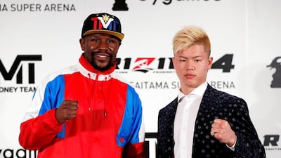 Undefeated boxer Floyd Mayweather Jr poses with his opponent Tenshin Nasukawa during a news conference in Tokyo. Reuters