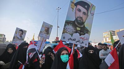 Some of the newcomers carried portraits of Hashed fighters killed while battling extremists, and of the country's influential Shiite cleric, Grand Ayatollah Ali Al Sistani. AFP