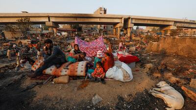 Slum dwellers return to their homes after a fire in Pakistan's southern city of Karachi. Reuters