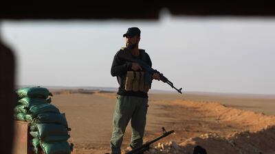 An Iraqi Shiite fighter of the Hashed Al Shaabi paramilitary force stands guard at a border position in Al Qaim in Iraq's Anbar province. AFP