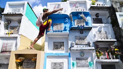People traditionally bring candles and flowers and pay respects to departed loved ones during All Saint's Day in the Philippines. Getty Images