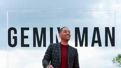 Will Smith, in checked tailoring and a red sweater, attends the 'Gemini Man' premiere at Buda Castle Savoy Terrace on September 25, 2019 in Budapest, Hungary. Getty Images