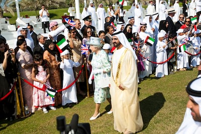 Sheikh Mohammed bin Rashid, Vice President and Ruler of Dubai, and Queen Elizabeth greet cheering crowds at Emirates Palace in November 2010. Andrew Henderson / The National