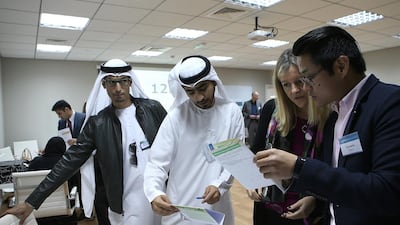 Bader Al Mansoori, left, with other participants during Protraining’s Vulcanus workshop in Abu Dhabi. Ravindranath K / The National