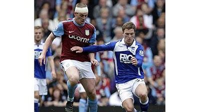 Richard Dunne, left, has battled away for Aston Villa this season.