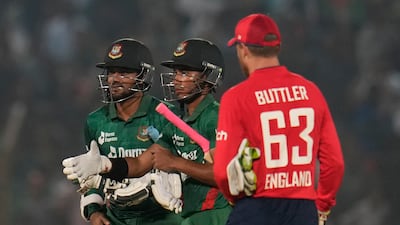 England's captain Jos Buttler, right, walks to greet Bangladesh's captain Shakib Al Hasan, left, and Afif Hossain after the first T20 in Chattogram on March 9, 2023. AP