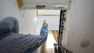A homeowner shows the damage left from water that poured through her proof and into her home. All photos by Ruel Pableo for The National