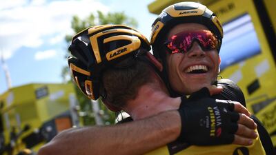 Belgium's Wout van Aert is congratulated by a teammate after winning the 10th stage of the Tour de France on Monday. Anne-Christine Poujoulat / AFP