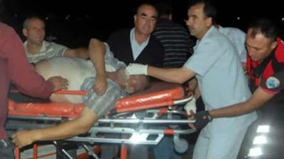 Medical workers assist a ferry passenger, after the vessel sank off Balikesir, in north western Turkey.