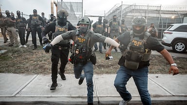 US Immigration and Customs Enforcement (ICE) agents charge at people protesting against the treatment of those held at Delaney Hall detention centre, where a hunger strike is taking place, in Newark, New Jersey. EPA
