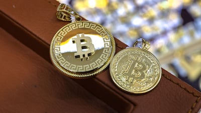 Bitcoin 18 karat gold pendants for sale at Madinat Zayed Gold Souk in Abu Dhabi. Victor Besa / The National
