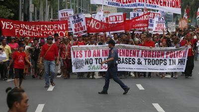 Protesters carry banners as they march towards the US embassy in Manila.