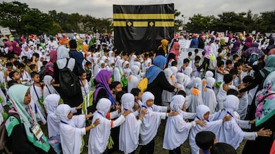 Thousands of Malaysian children took part in a practice run for the Muslim haj pilgrimage on July 24, walking round a model of the holy Kaaba shrine under the tropical sun. The haj is one of the five pillars of Islam, which capable Muslims must perform at least once, and marks the spiritual peak of their lives. All photos by Mohd Rasfan / AFP
