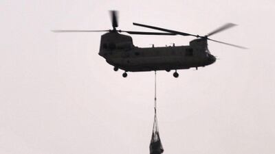 In this photograph taken on July 29, 2011, a US military Chinook helicopter transport cargo over Arghandab district. Thirty-one US special forces and seven Afghans died when the Taliban shot down their helicopter, officials said on August 6, 2011/