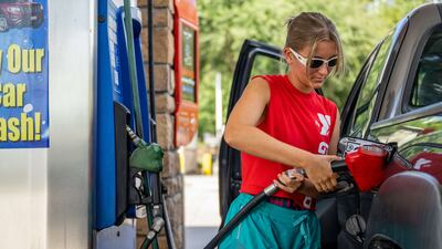 A customer pumps gas at an Exxon gas station on July 29, 2022 in Houston, Texas. AFP