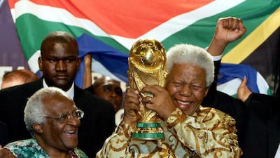 Nelson Mandela played a significant role in South Africa's clinching of the Fifa World Cup hosting rights in 2010. Here he was posing with the Jules Rimet trophy with Archbishop Desmond Tutu. Franck Fife / AFP