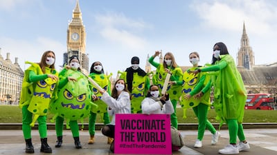 Activists from the anti-poverty organisation the ONE Campaign stage a protest calling for the sharing of coronavirus vaccines with developing countries in Parliament Square in London. EPA