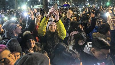 Revellers seen shortly before fireworks light up the sky above the London Eye during the new year celebrations in London on December 31, 2019. Getty Images