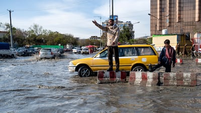 A policeman directs traffic during floods in Kabul, Afghanistan. AFP