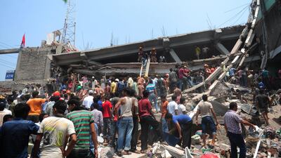Bangladeshi Army personnel and civilian volunteers work on the scene. AFP Photo / Munir uz Zaman