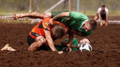 Members of Saint Petersburg Lakes and Pogi teams compete in the Swamp Football Cup of Russia in the village of Pogi in Leningrad Region, Russia June 16, 2018. Anton Vaganov / Reuters