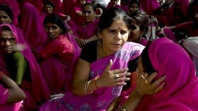 Leader of the Gulabi Gang, Sampat Pal Devi (C) gestures as she chats with members during a protest in New Delhi in 2009. The Gulabi Gang (Pink Gang), a group of women in rural India who strive for social justice, don pink saris and fight for women's rights and better conditions for the poor.