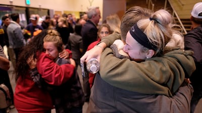 People comfort each other after a candlelight vigil for the victims of the mass shooting. AP Photo