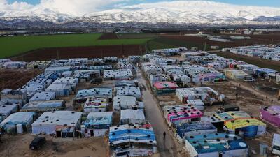 An aerial view shows an informal tent settlement housing Syrian refugees in the area of Delhamiyeh, in the central Bekaa Valley. Lebanon plays host to over one million Syrian refugees who fled as neighbouring Syrian fell into civil war at the start of March 2011. AFP