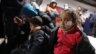 Palestinians mourn over the body of a child killed in Israeli overnight airstrikes in the northern Gaza Strip, at the Indonesian Hospital in Beit Lahia on March 20, 2025. Israel bombarded Gaza and pressed its ground operations on March 20, after issuing what it called a "last warning" for Palestinians to return hostages and remove Hamas from power. (Photo by BASHAR TALEB / AFP)