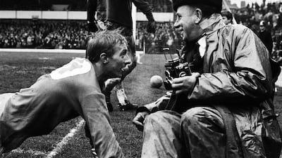 Denis Law takes a breather in front of fans and photographers in 1965. Getty