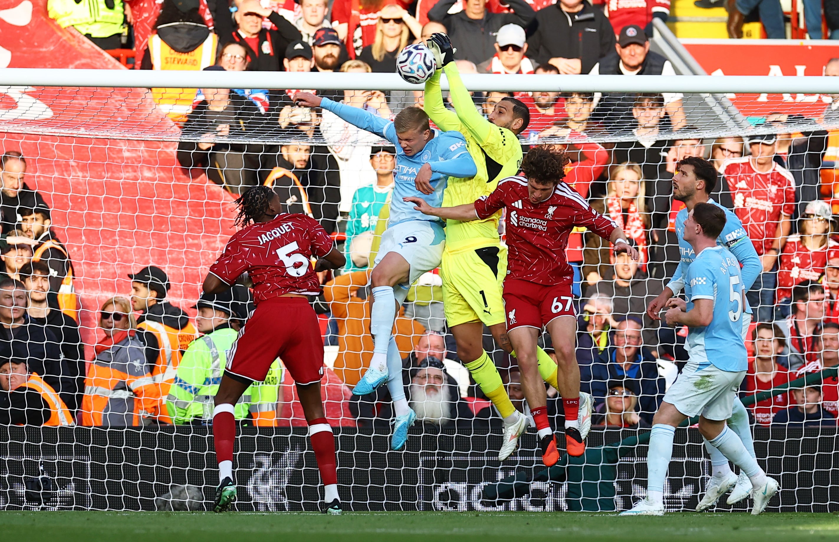 City's Erling Haaland and Gianluigi Donnarumma under pressure from Lewis Koumas of Liverpool. Reuters