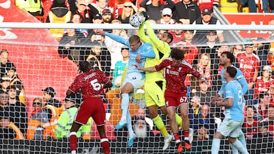 City's Erling Haaland and Gianluigi Donnarumma under pressure from Lewis Koumas of Liverpool. Reuters