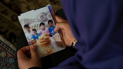 In this Aug. 20, 2018, photo, Meripet, 29, hasn't seen her other four children since, and heard they were taken to a live-in kindergarten in Hotan, China. AP