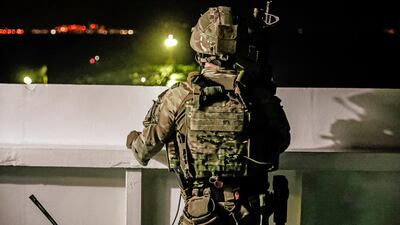 A British soldier looks on during an operation involving the oil supertanker Grace 1, which is suspected of trying to take Iranian crude oil to Syria. UK Ministry of Defence