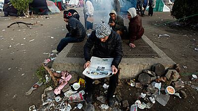 A protester in Tahrir Square reads a newspaper a day after Egypt's January 25 anniversary.