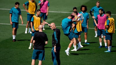 Real Madrid manager Zinedine Zidane talks to a coach during training ahead of the Uefa Champions League final. Gabriel Bouys / AFP