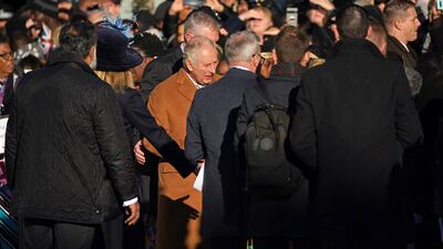 Close-protection officers usher King Charles out of the way as he meets members of the public. An egg is believed to have been thrown at him as he toured Luton town centre. PA